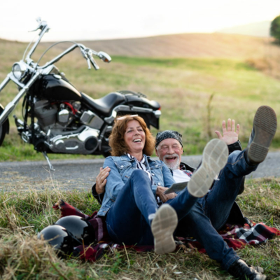 a-cheerful-senior-couple-travellers-with-motorbike-2024-10-18-17-40-32-utc